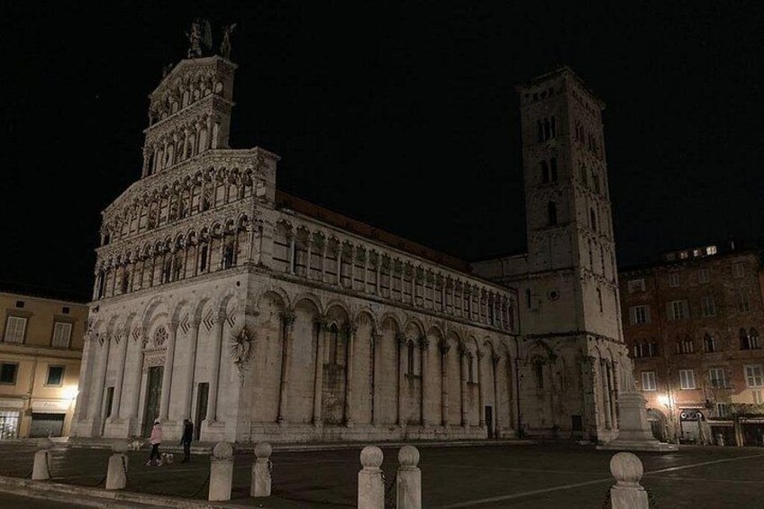 A historic building with a prominent tower and arched windows. 3