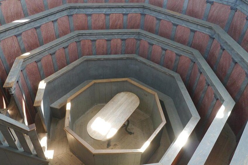 A spiral staircase with a wooden floor and metal railings. 2