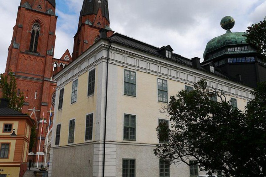 A historic building with a clock tower and a dome. 2