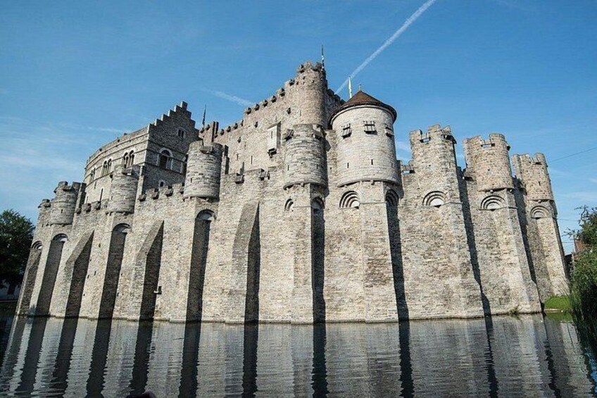 A large stone castle with multiple towers and arched windows. 1