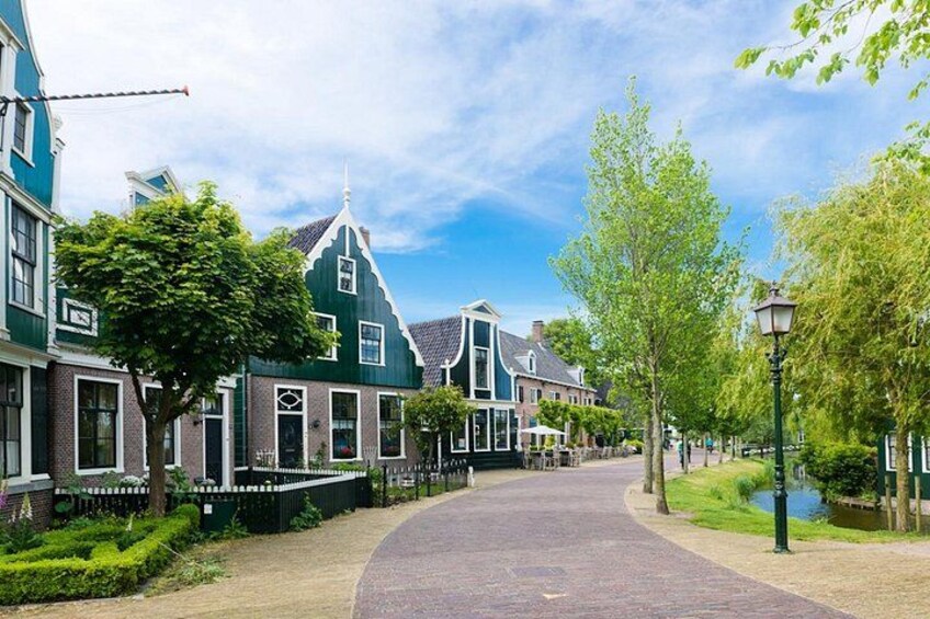 A street lined with traditional houses, a curved pathway, and a lamppost. 5