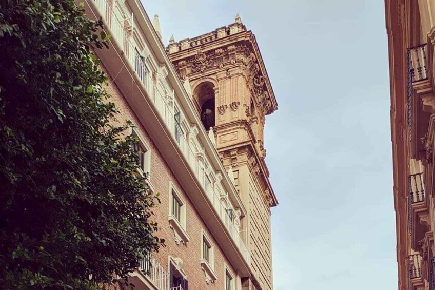 A tall building with ornate architectural details and a large arched window. 1