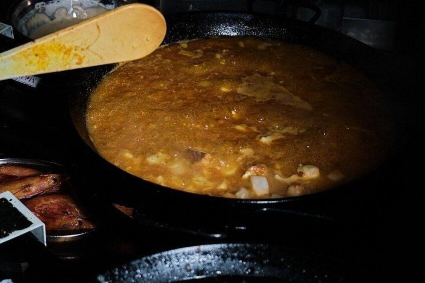 A pot of stew with a wooden spoon. 2