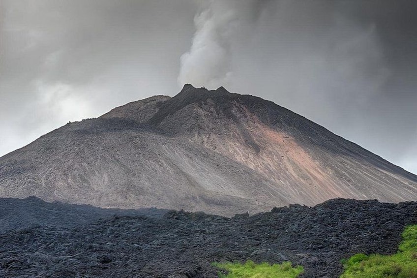 A mountain with a dark crater at its base. 1