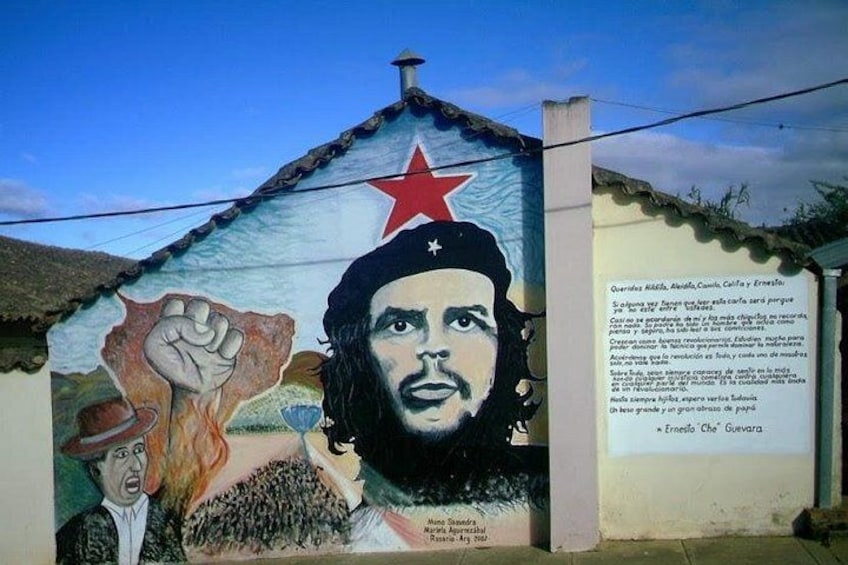 A mural with a red star, a clenched fist, and a portrait of a man. 5