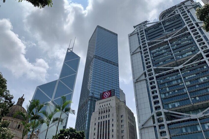 A cityscape with modern skyscrapers, palm trees, and a clear sky. 4