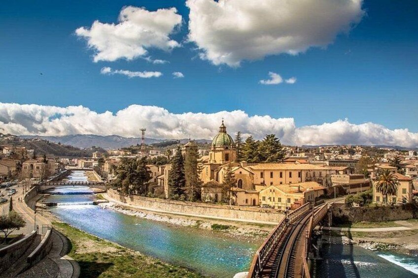 A river, a bridge, and a historic building with a dome. 1