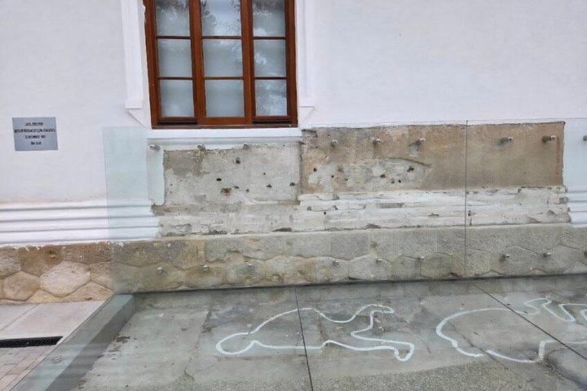 A building facade with a window, stone steps, and graffiti. 5