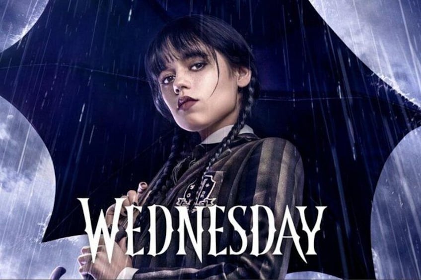 A person holding an umbrella with the text 'WEDNESDAY' visible. 1