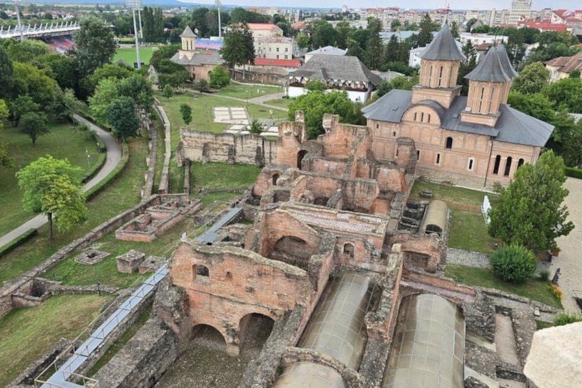 An ancient fortress with ruins and a church with two towers. 5