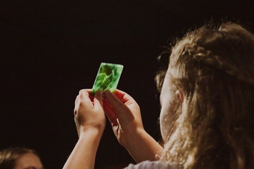 A person holding a green card. 1