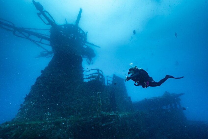 A diver exploring an underwater shipwreck. 4
