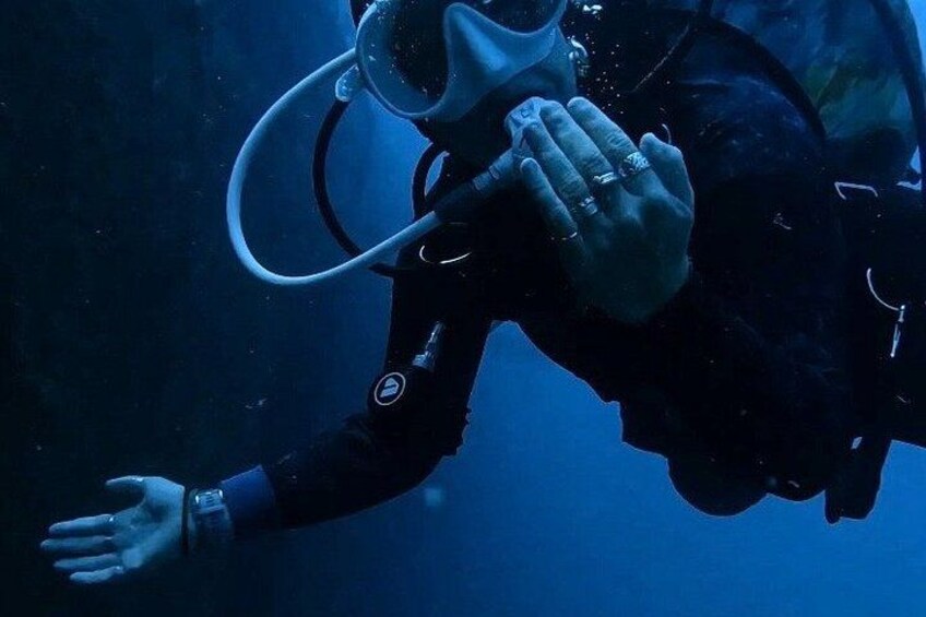 A diver underwater with a diving mask and fins. 2