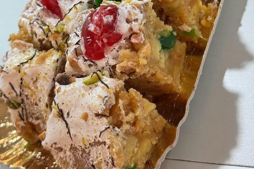 A dessert with nuts and a cherry on top. 2