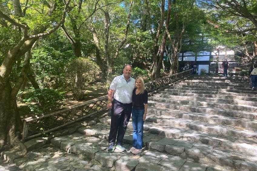 A stone staircase surrounded by trees in a park. 1