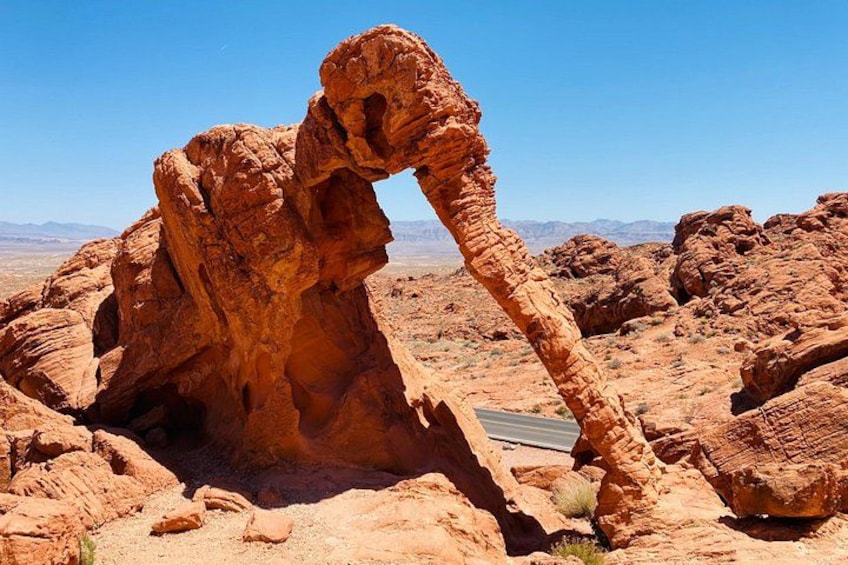 A large rock formation with a prominent arch. 3