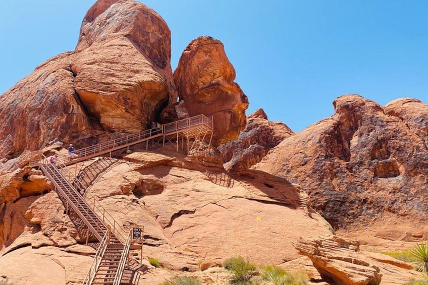 A rocky landscape with a staircase leading up to a large rock formation. 5