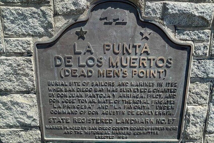 A historical marker plaque titled 'La Punta de los Muertos (Dead Men's Point)' with details about the burial site of sailors and marines. 4