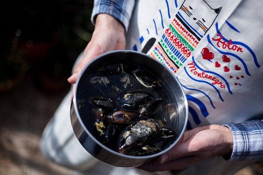 A person holding a bowl of fish. 4