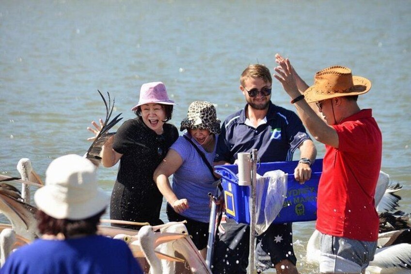 People on a boat, water, and a blue cooler. 2