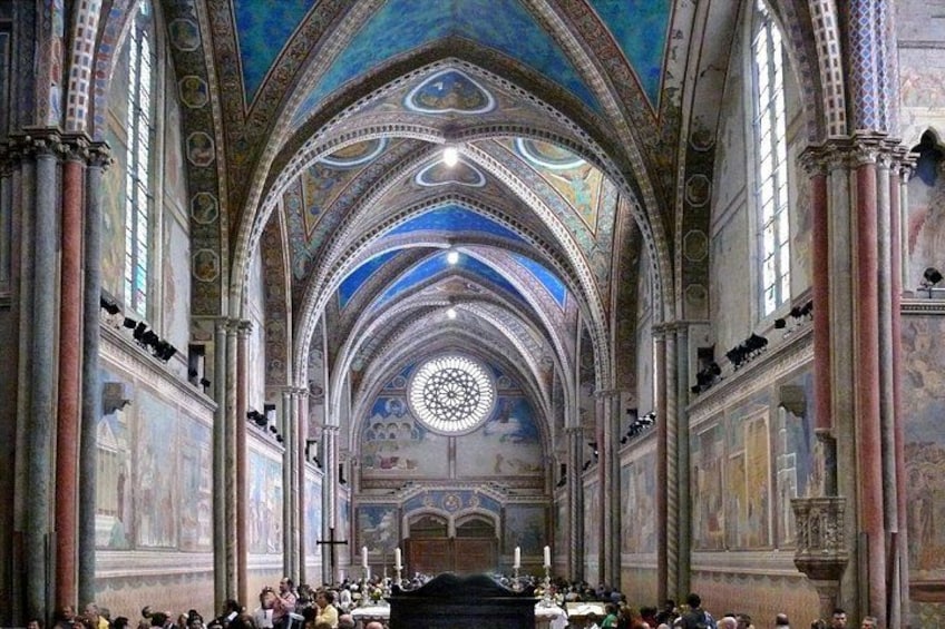 An ornate church interior with high ceilings, arched windows, and detailed frescoes. 5