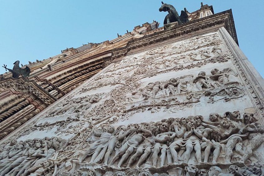 A detailed sculpture of a battle scene on a building's facade. 5