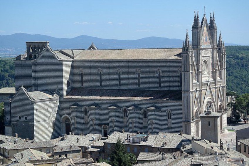A large cathedral with a prominent bell tower and a surrounding town. 4