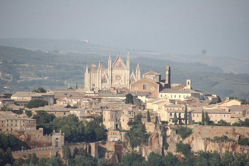 A cathedral with a tall spire, surrounded by a town with historic buildings. 3