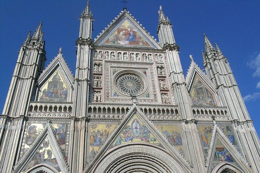 A Gothic cathedral with intricate facades, pointed arches, and detailed stained glass windows. 1