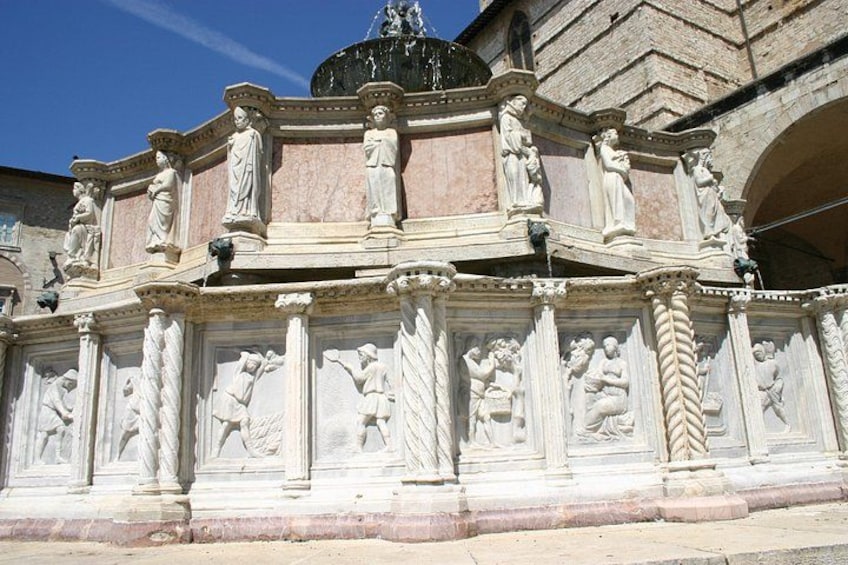 A detailed stone relief sculpture with figures and architectural elements. 5