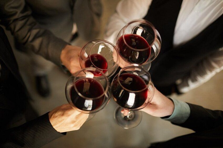 A group of people holding wine glasses. 1
