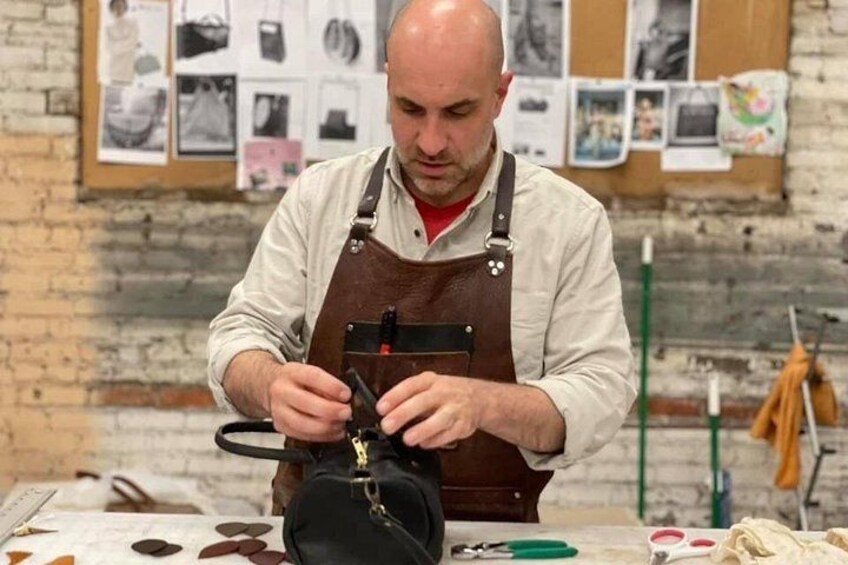 A person working with a sewing machine, surrounded by tools and materials. 3