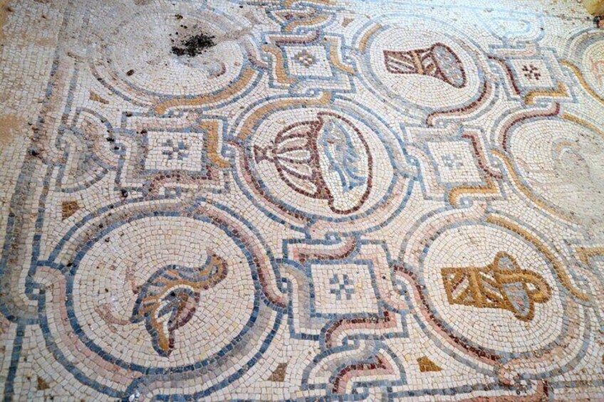 A detailed mosaic with geometric patterns and animal motifs. 2