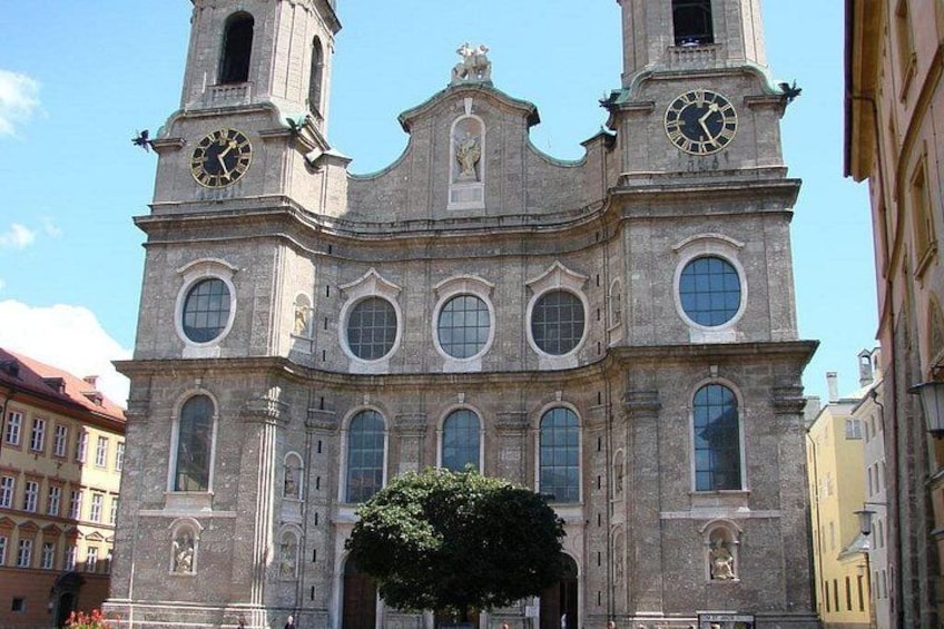 A historic church with two clock towers, arched windows, and a central entrance. 5