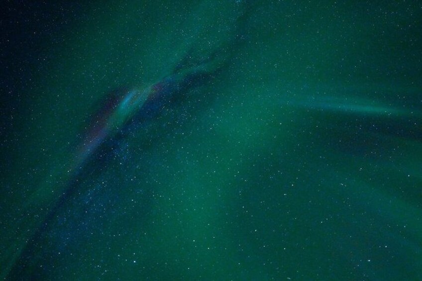A starry night sky with visible aurora borealis. 2