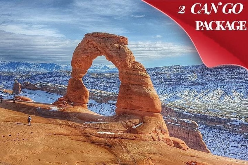 A large rock arch formation with a snowy landscape in the background. 2