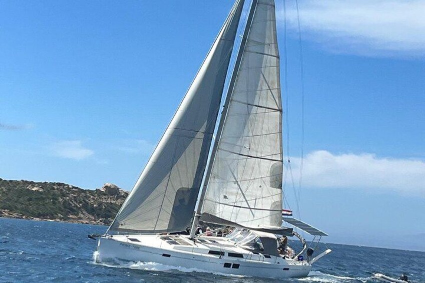 A sailboat with a single mast sailing on the water. 3