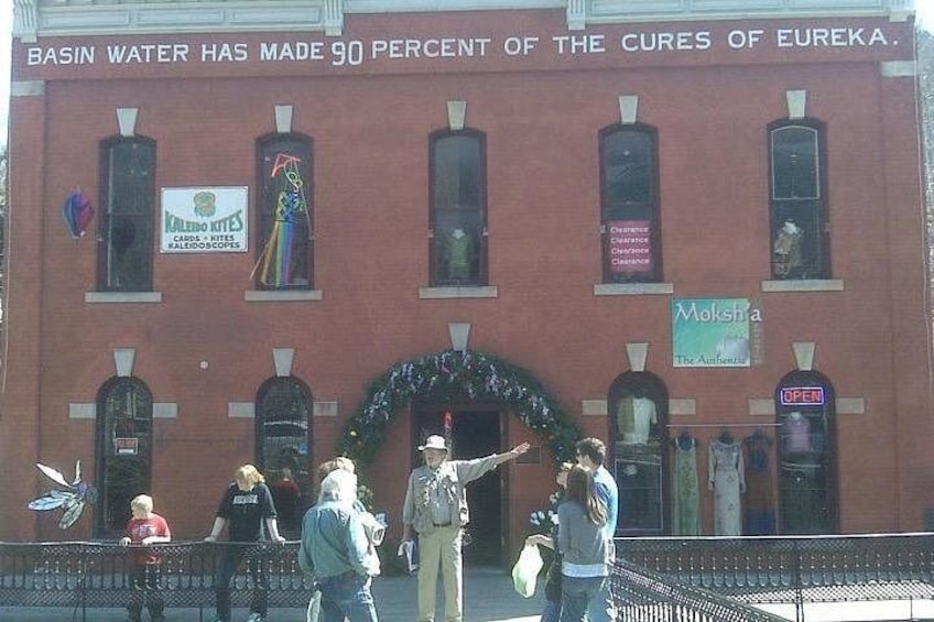 A red brick building with a sign stating 'Basin Water has made 90 percent of the cures of Eureka.' 5