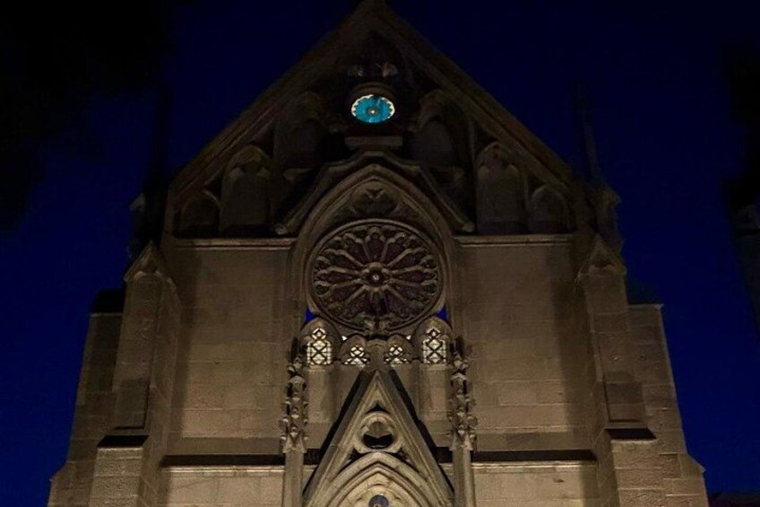 Un clocher d’église de style gothique, doté d’une grande rosace et d’une horloge au sommet. 2