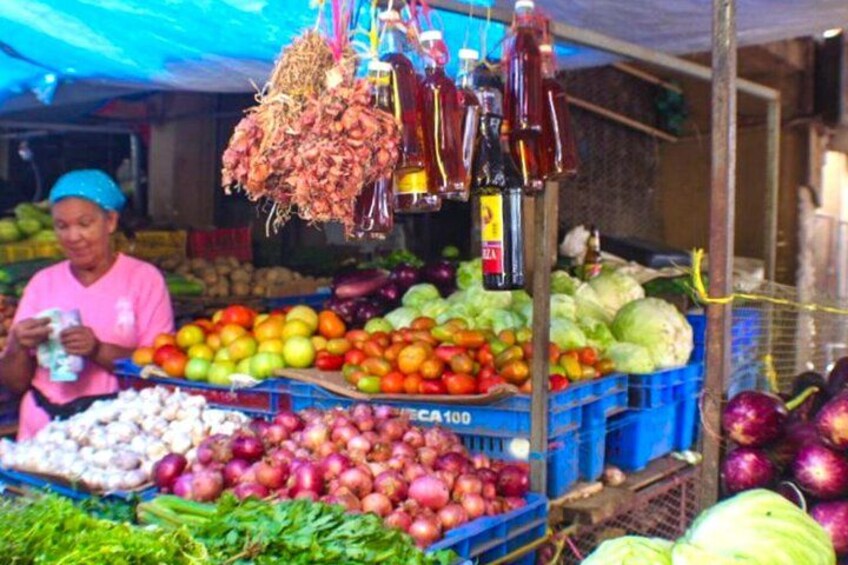 A market stall with fresh produce, including apples, onions, and cabbage. 3