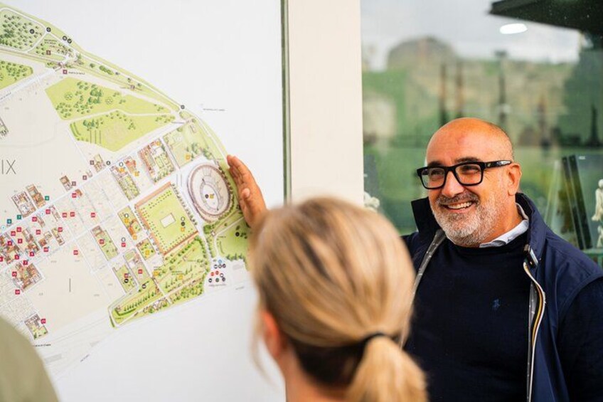 A person holding a map with a circular structure and various labeled areas. 3