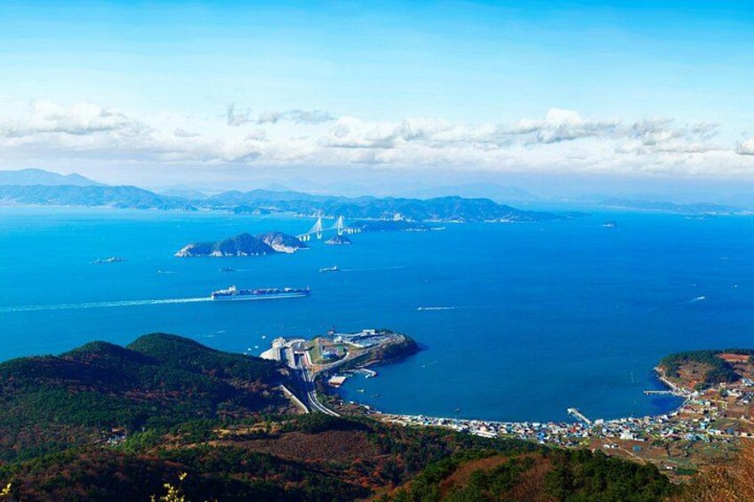 A coastal landscape with a bridge, a ship, and a small town. 5