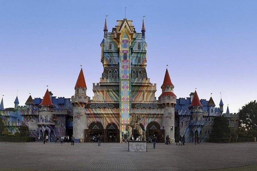 A large, colorful castle with multiple towers and a central spire. 1