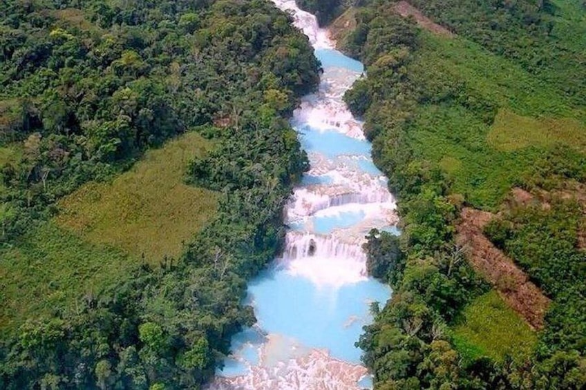 A river flowing through a forested valley with waterfalls. 1