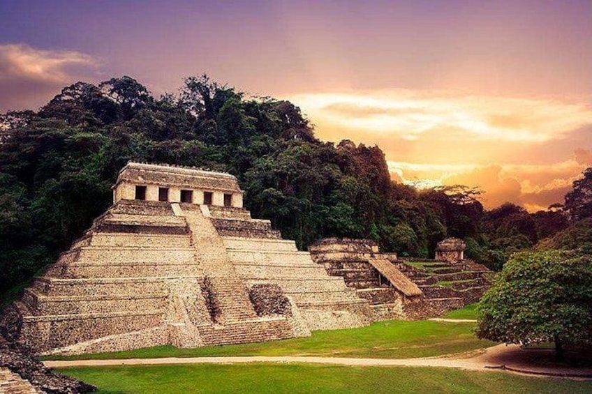 Ancient stone pyramids, lush greenery, and a clear sky. 4