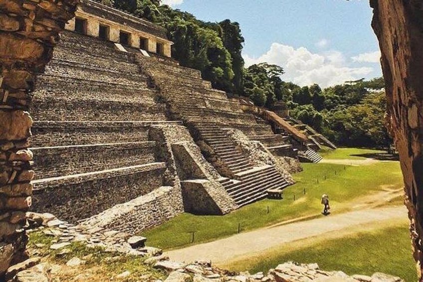 Ancient stone steps leading up to a temple, surrounded by lush greenery. 3