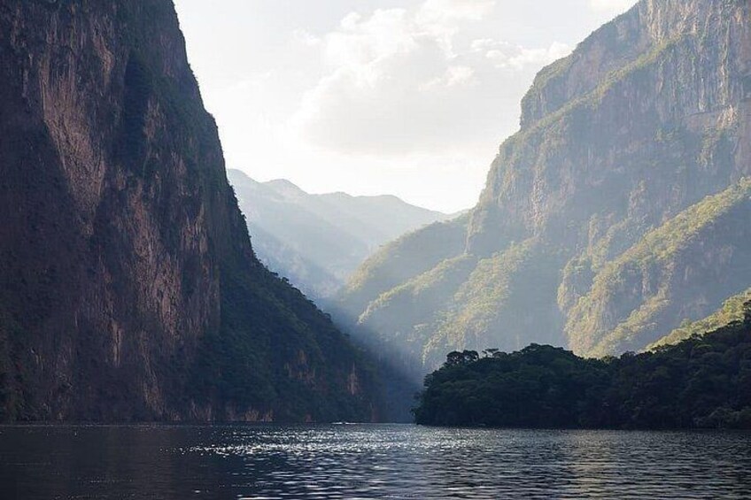 A river canyon with steep cliffs and a small island in the middle. 3