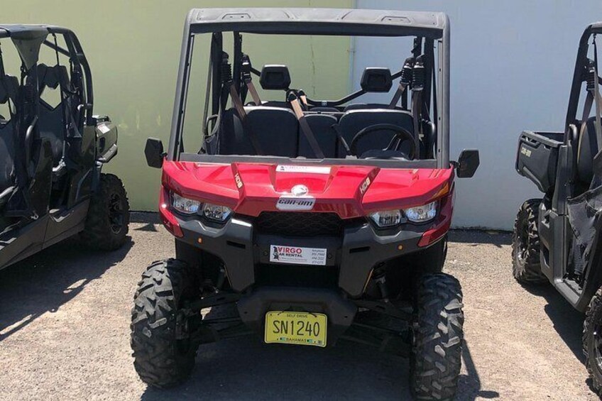 A red ATV with a license plate SN1240 parked in a lot. 4
