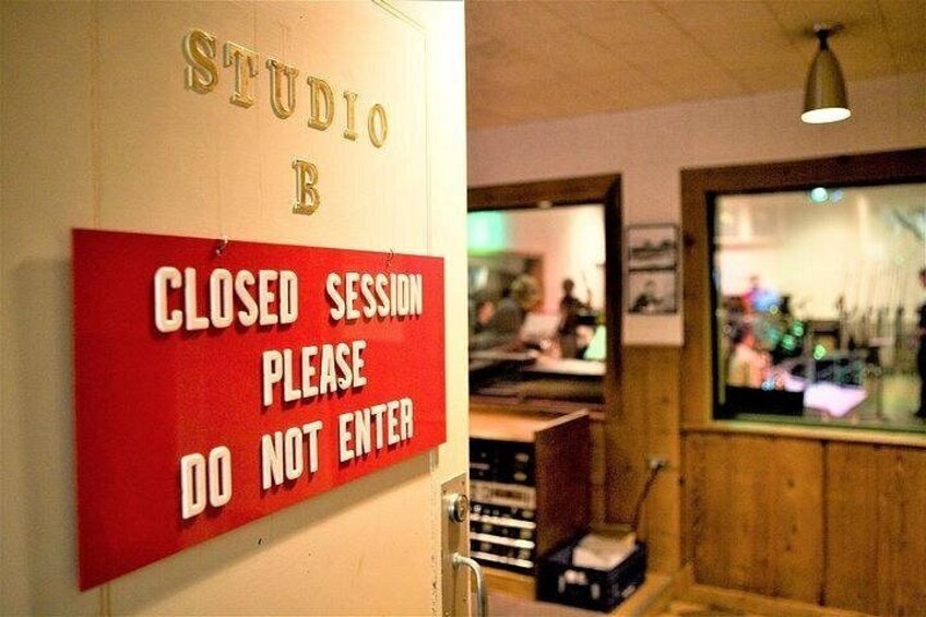 A closed session sign, a wooden interior, and a window with reflections. 4