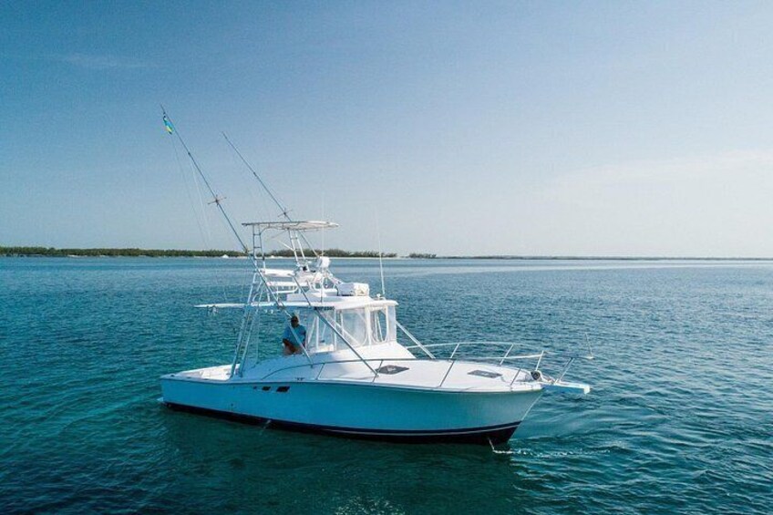 A white boat on calm water with a clear sky. 5